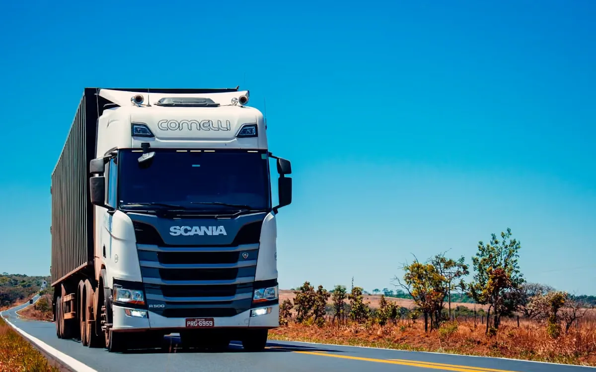 Articulated heavy truck on an open road, representing Bex-Drive Code 14 training
